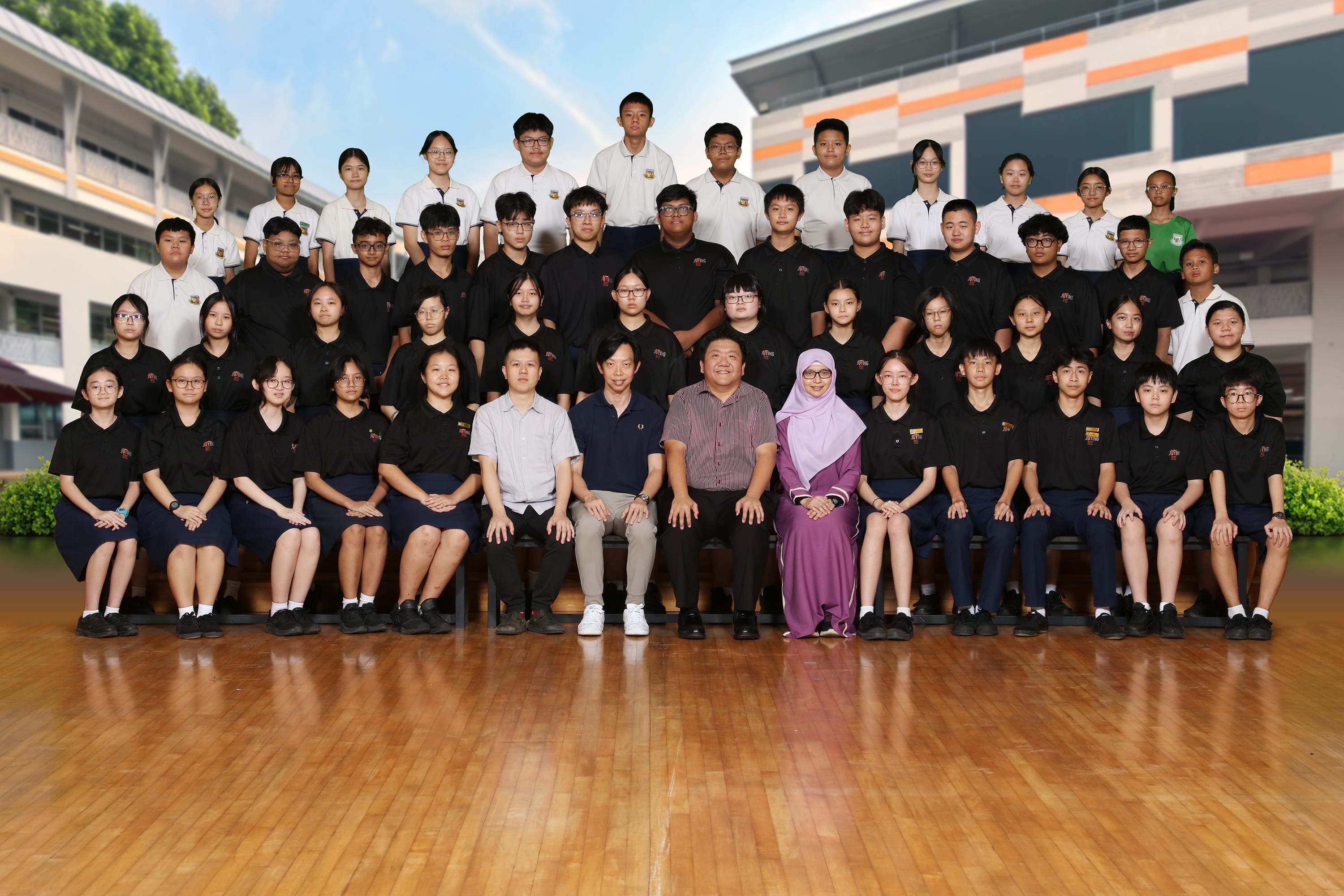 2024 group photo of Juying Secondary School Symphonic Band members and teachers in uniform, posed in rows.
